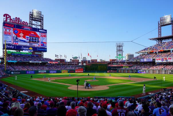 People sitting behind home plate in Citizens Bank Park stadium watching the Philadelphia Phillies play baseball