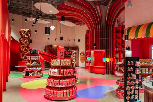 Interior of a colorful chocolate store with product stands in the middle of the room