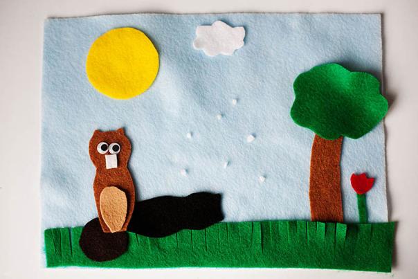 A craft of a groundhog with a tree and sun overhead