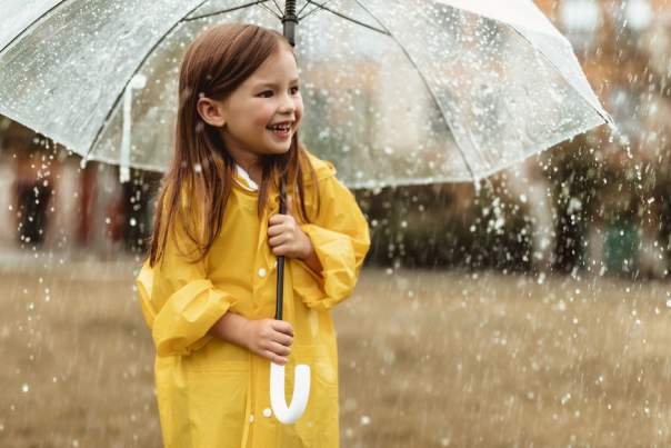 Child holding an umbrella in the rain