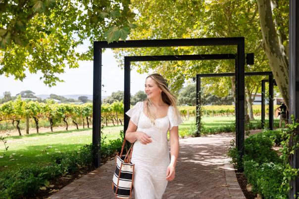 woman walking through winery