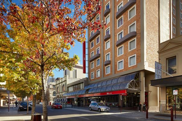 image of autumn tree and brick hotel building