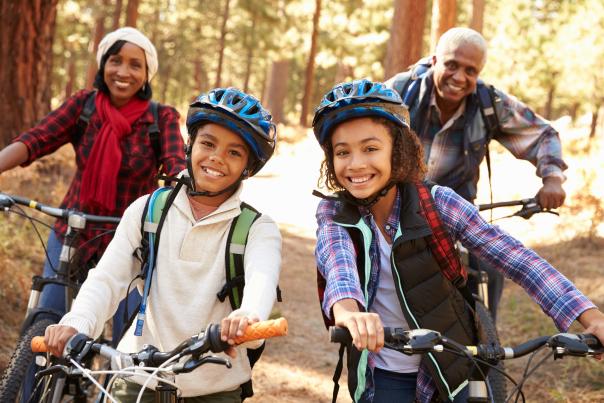 A family enjoys a fall bike ride.