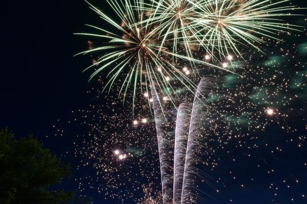 A view of fireworks going off in the night sky.
