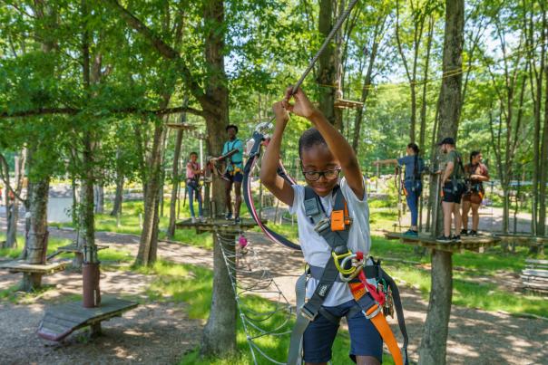 A little boy crosses a treetop ropes course at Kalahari's Gorilla Grove in the Poconos.