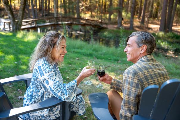 A couple raises their wine glasses at Three Hammers Winery in the Poconos.