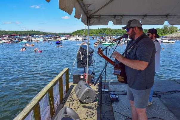 A singer performs on a floating stage at Wally Lake Fest in the Poconos.