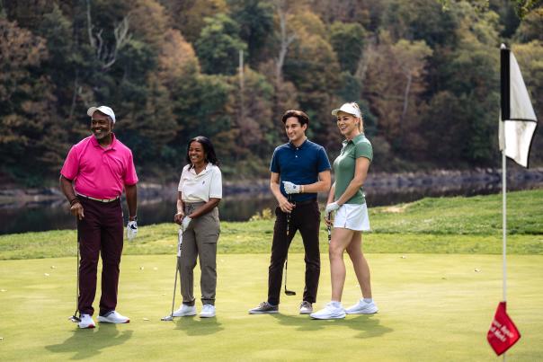 A group of golfers stands on the green at the Shawnee Inn and Golf Resort in the Poconos.