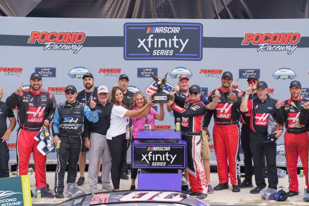 The Pocono Television crew celebrates with the winners of the 2024 NASCAR race at Pocono Raceway.