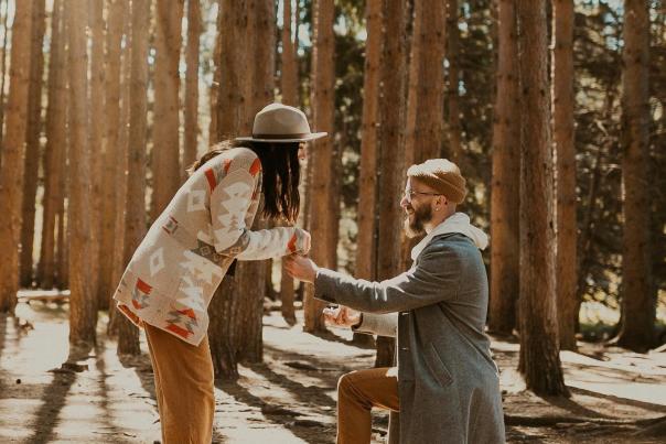 A man gets down on one knee for a storybook proposal in the Pocono Mountains.