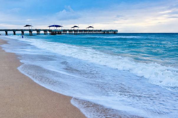 Rolling waves on Pompano Beach with the Fisher Family Pier in the distance