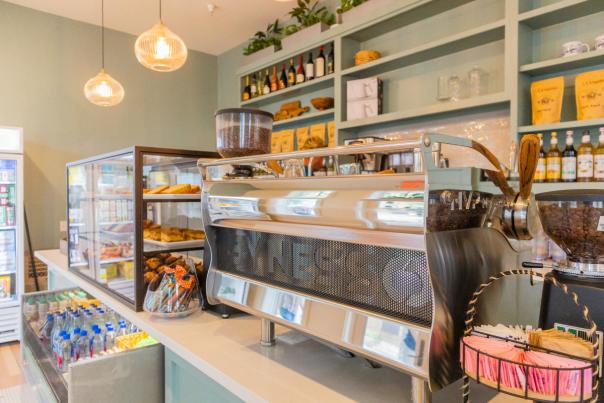 Interior of Shore Cafe featuring a service counter, display cases with pastries, and warm lighting.
