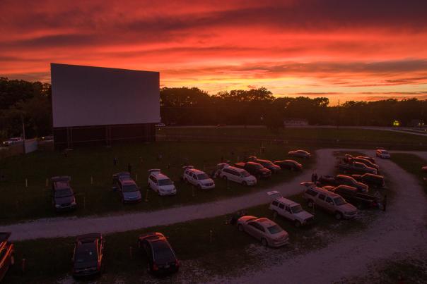 A beautiful sunset covers the sky in orange light at the 49er Drive-In Theater.