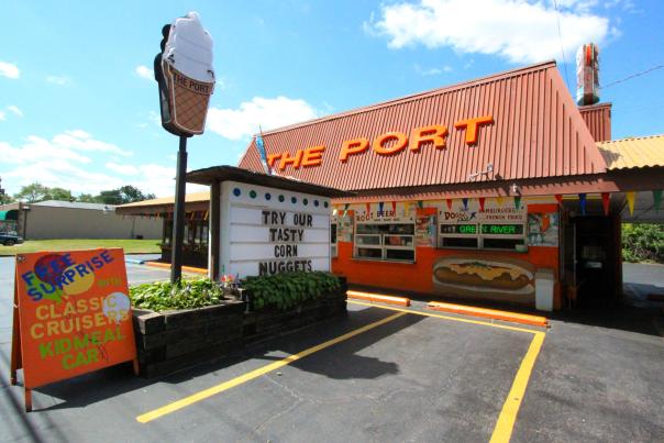 An orange and brown building with the words "The Port" on the room. An ice cream cone sign is out in front.