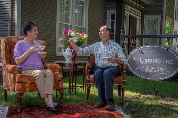 The owners of the Valparaiso Inn sit outside drinking tea.