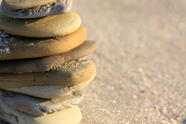 A stack of rocks on a sandy beach