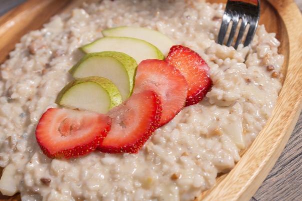 risotto on a plate with strawberries and pear