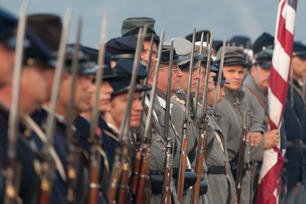 An image of men dressed as soldiers in a civil-war reenactment