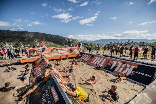 Tough Mudder Classic participants navigating through mud pit obstacle