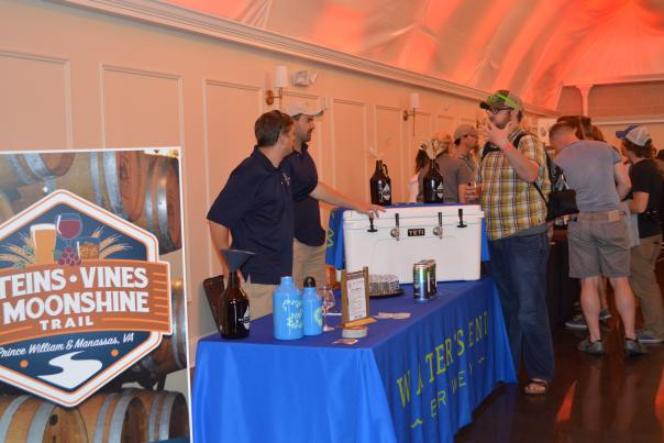 people standing at a table at a trade show