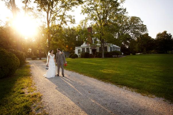 Bride and Groom walking along path in front of Rippon Lodge Historic Site