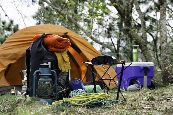 Camping gear in front of a tent in a forest