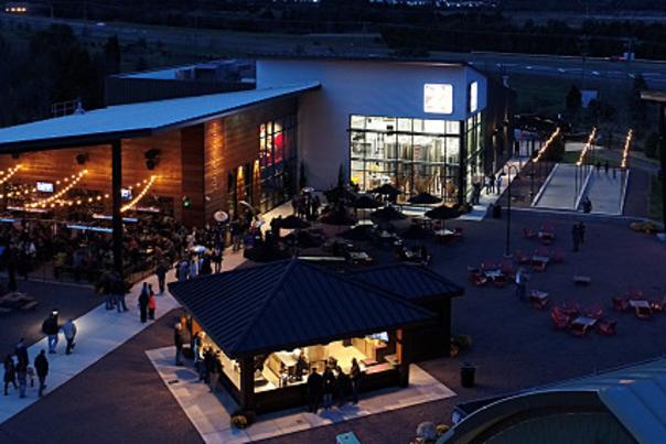 A pavilion and outdoor stage with patio at night