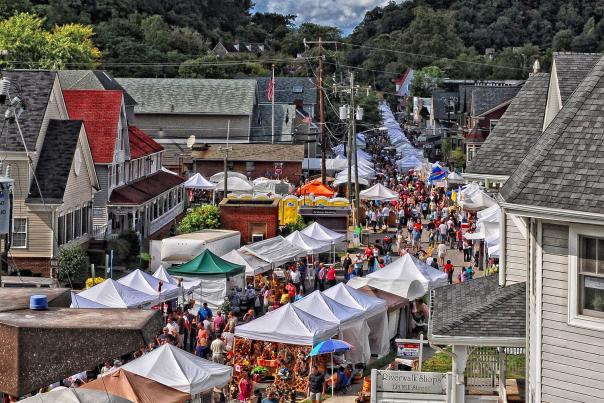 tents and crowds of people in the street for a festival