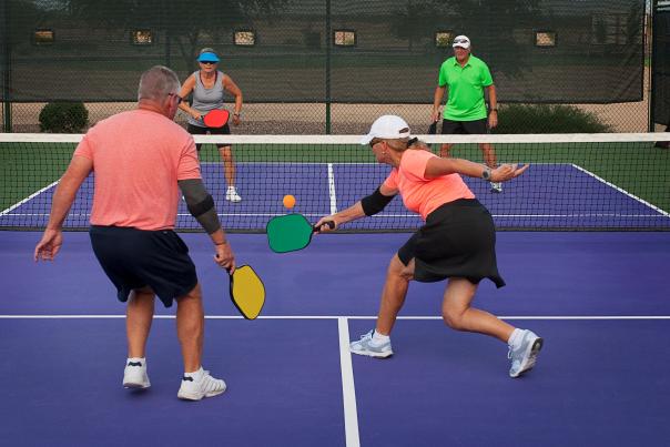 2 couples playing pickleball