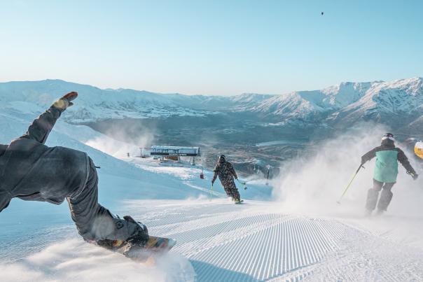 Skiers shredding Coronet Peak mountain