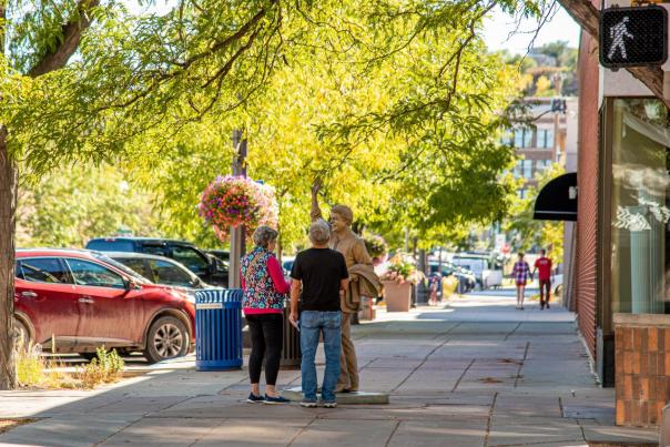 Man and women standing next to Jimmy Carter statue in the spring in the City of Presidents in downtown Rapid City