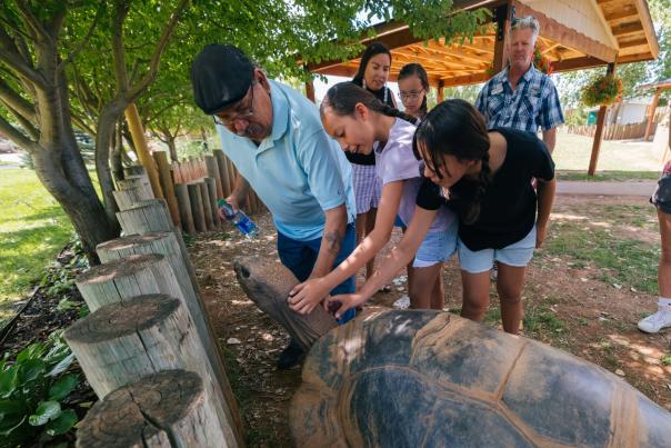 family petting a giant tortoise at Reptile Gardens in Rapid City, SD