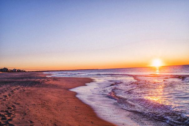 Golden sunset over the ocean at a sandy beach