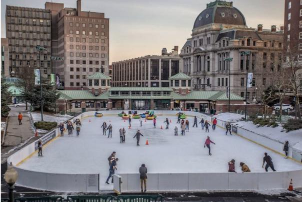 People ice skating at the Providence Rink on a winter day.