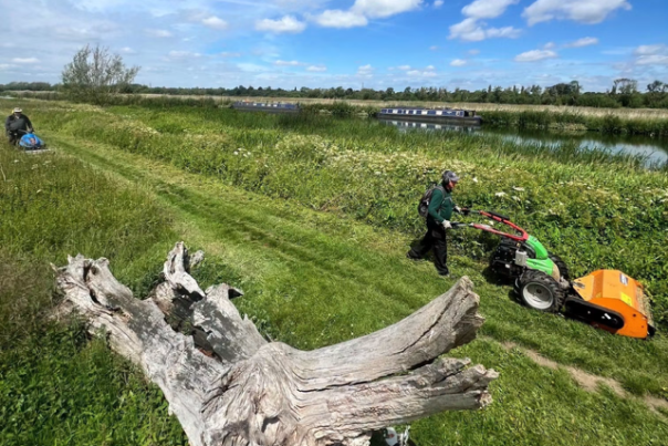 Volunteers mowing