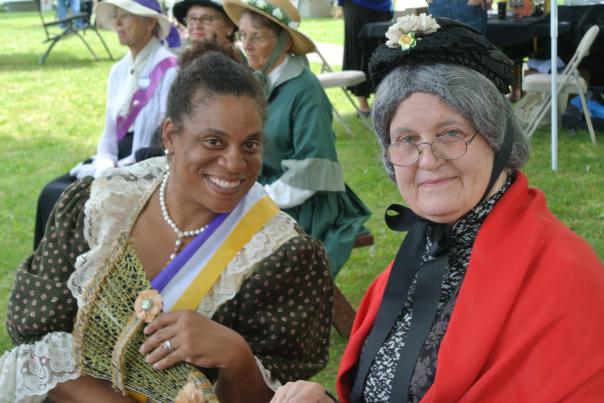 Ida B. Wells and Susan B. Anthony sit togehter in a park