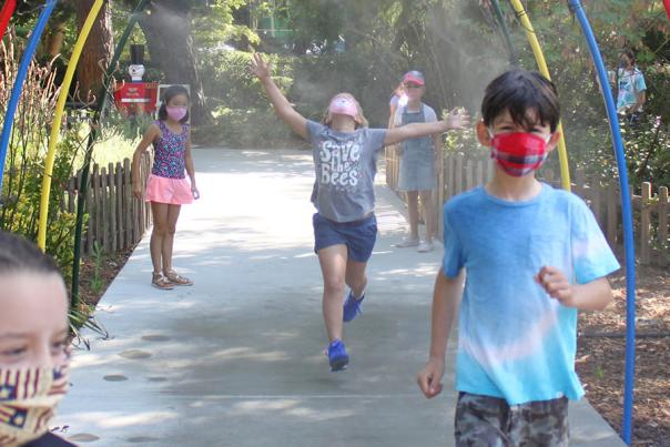 children enjoying misters at outdoor park