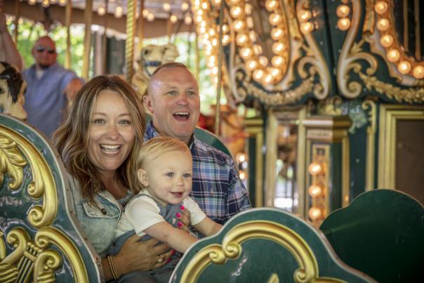 Family on carousel at Dan Nicholas Park