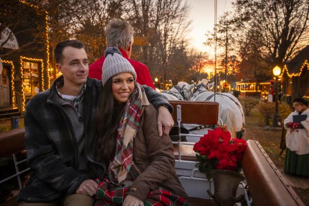 Man and woman in winter attire on carriage ride