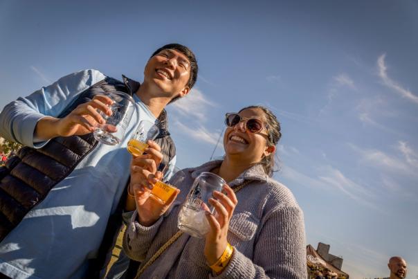 People smiling holding beer