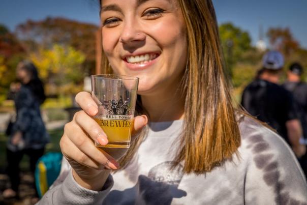 Woman holding tasting glass at Bell Tower BREWFEST