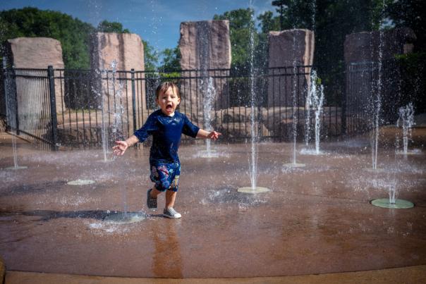 Kid playing on splash pad at Dan Nicholas Park