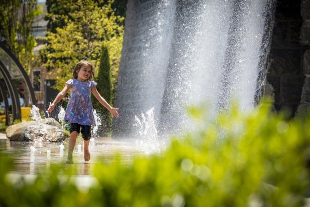 Girl playing in park water feature