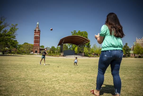 Family playing football at park