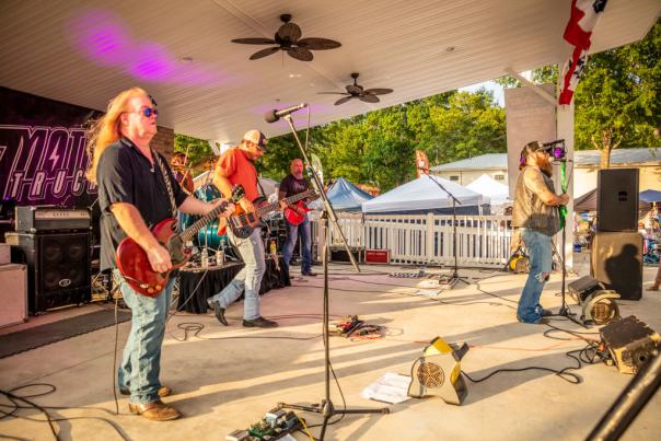 Band performing on small outdoor stage