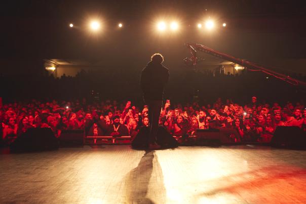 Performer on stage in front of cheering audience