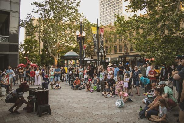 Crowd of people surrounding a performer on the streets of Salt Lake