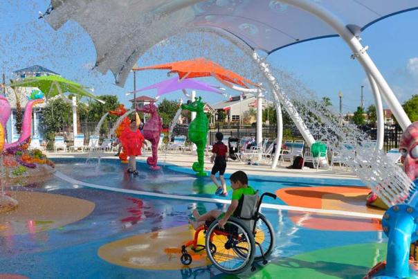 Person in wheelchair wheeling through waterpark