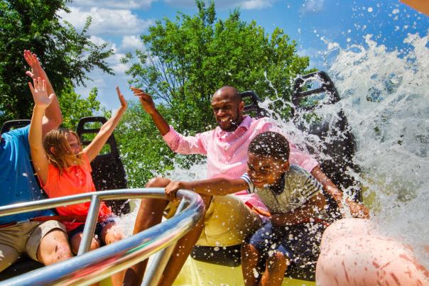Family on circular ride being splashed