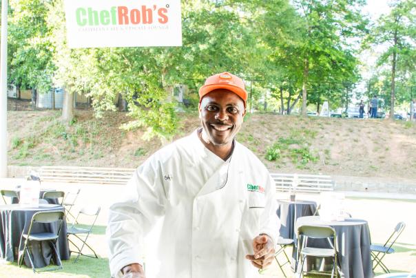 A photo of Chef Rob of Chef Rob's Caribbean Cafe Serving Food at the Annual Food That Rocks Event
